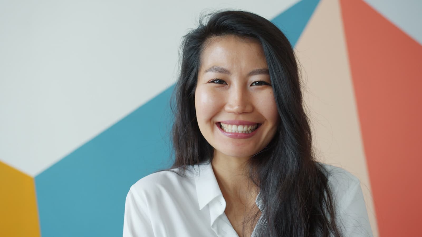 Smiling woman against a colorful background, professional portrait