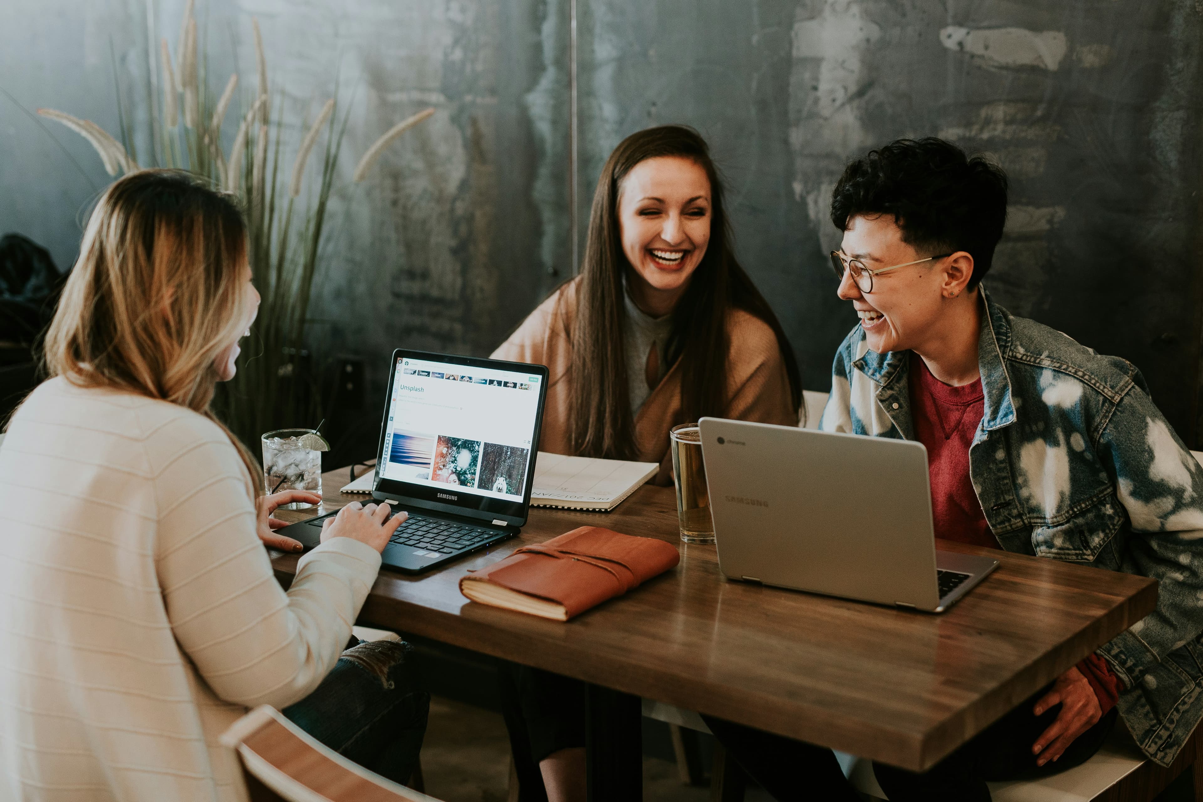 Developers collaborating around laptops